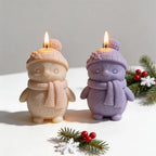 Cream and purple winter bird candles with pom-pom hats and scarves