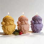 Three Santa face candles with textured hat bands and long beards