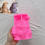 Pink silicone Christmas tree hat gnome mold beneath finished examples