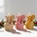 Cream pink and yellow gingerbread cupcake candles with spiral lollipops