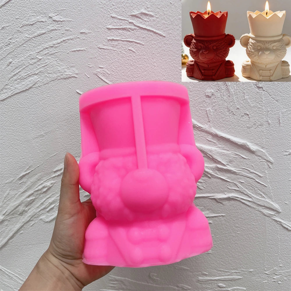 Pink silicone crowned bear vessel mold held in a hand