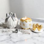 Bow-lidded decorative vessels styled with winter greenery