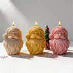 Cream yellow and pink Santa face candles with flowing beards