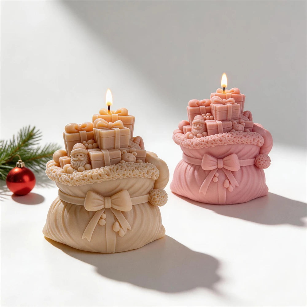 Cream and pink Christmas gift-sack candles with wrapped presents and ribbon bows