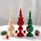Cream red and green ornamental candles with pointed tips