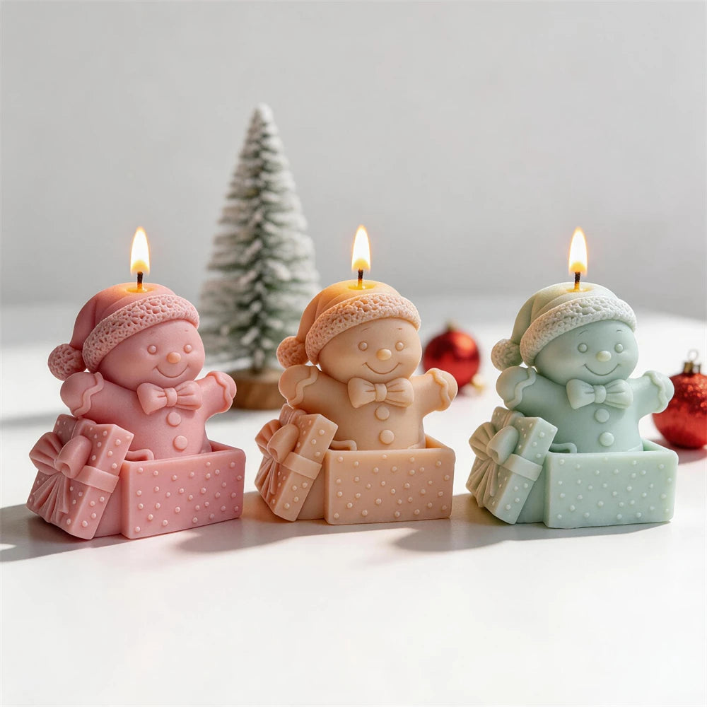 Gingerbread gift box candles decorated with Christmas greenery