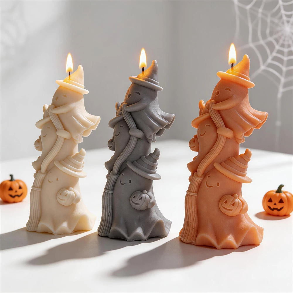 Stacked ghost candles showing pointed hats and small pumpkin details