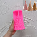 Pink star-topped Christmas tree silicone mold held in one hand