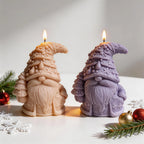 Two bearded gnome candles with ornamented tree hats and patterned coats