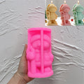 Pink silicone mold for winter figure holding candy cane