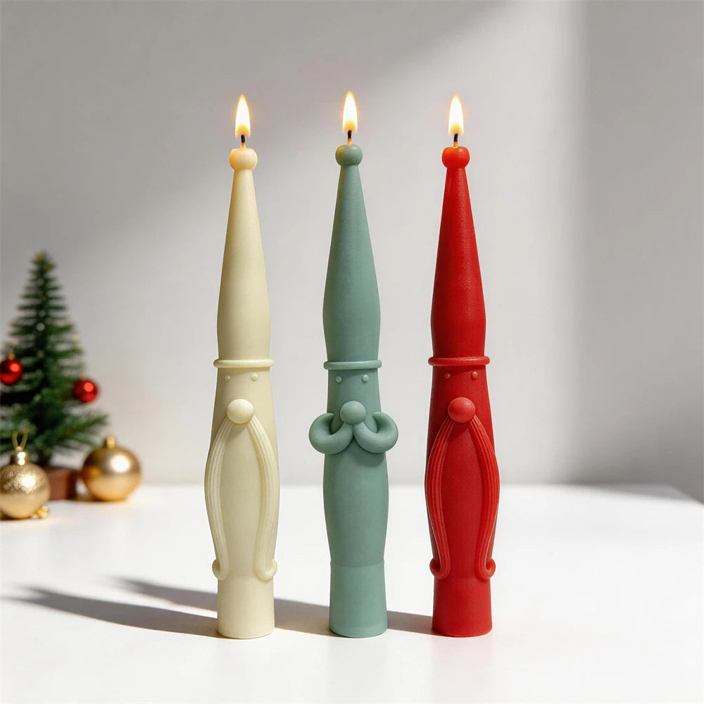 Tall holiday tapers shown in cream, green and red with two facial motif styles