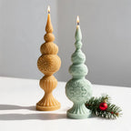 Tall yellow and shorter green finial castings on fluted pedestals