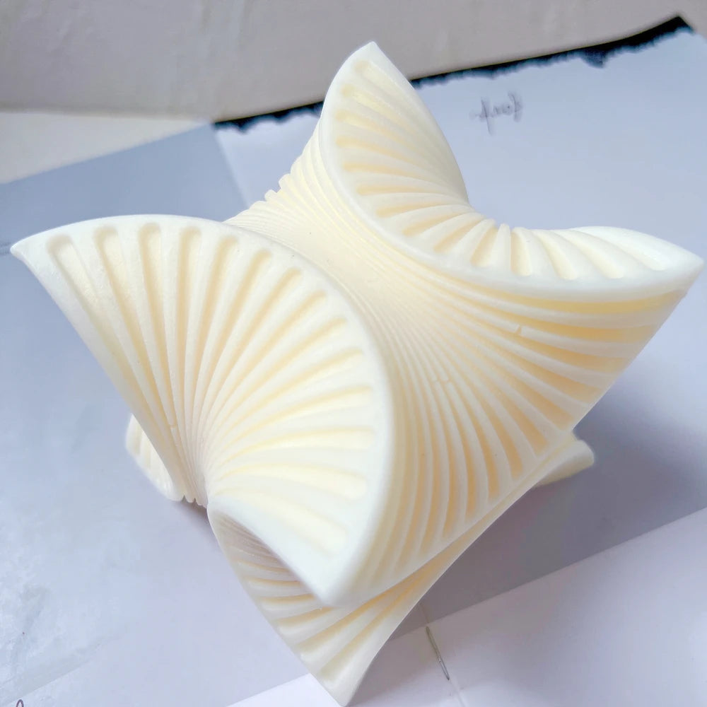 Angled four-fan swirl showing radiating grooves and pointed corners
