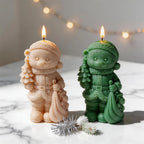 Cream and green Christmas bear candles beneath festive lights