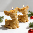Close view of gold reindeer candles with a seated pose and sculpted fur