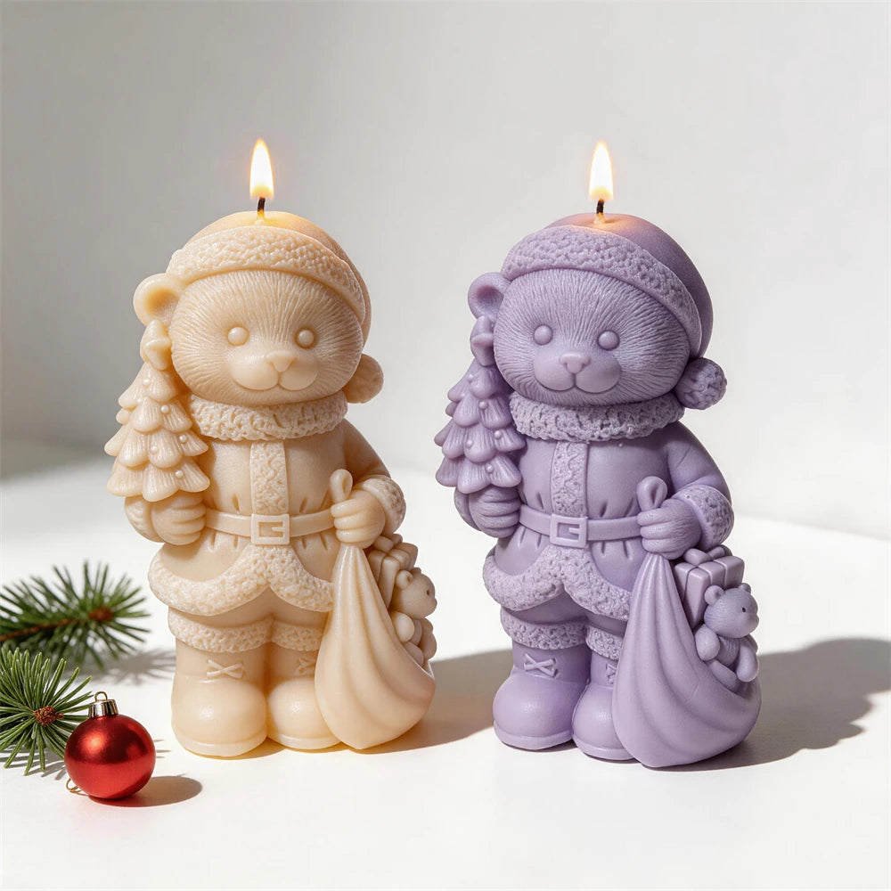Two Christmas bear candles with tiny bears peeking from sacks