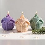 Front view of three rounded gingerbread house candles