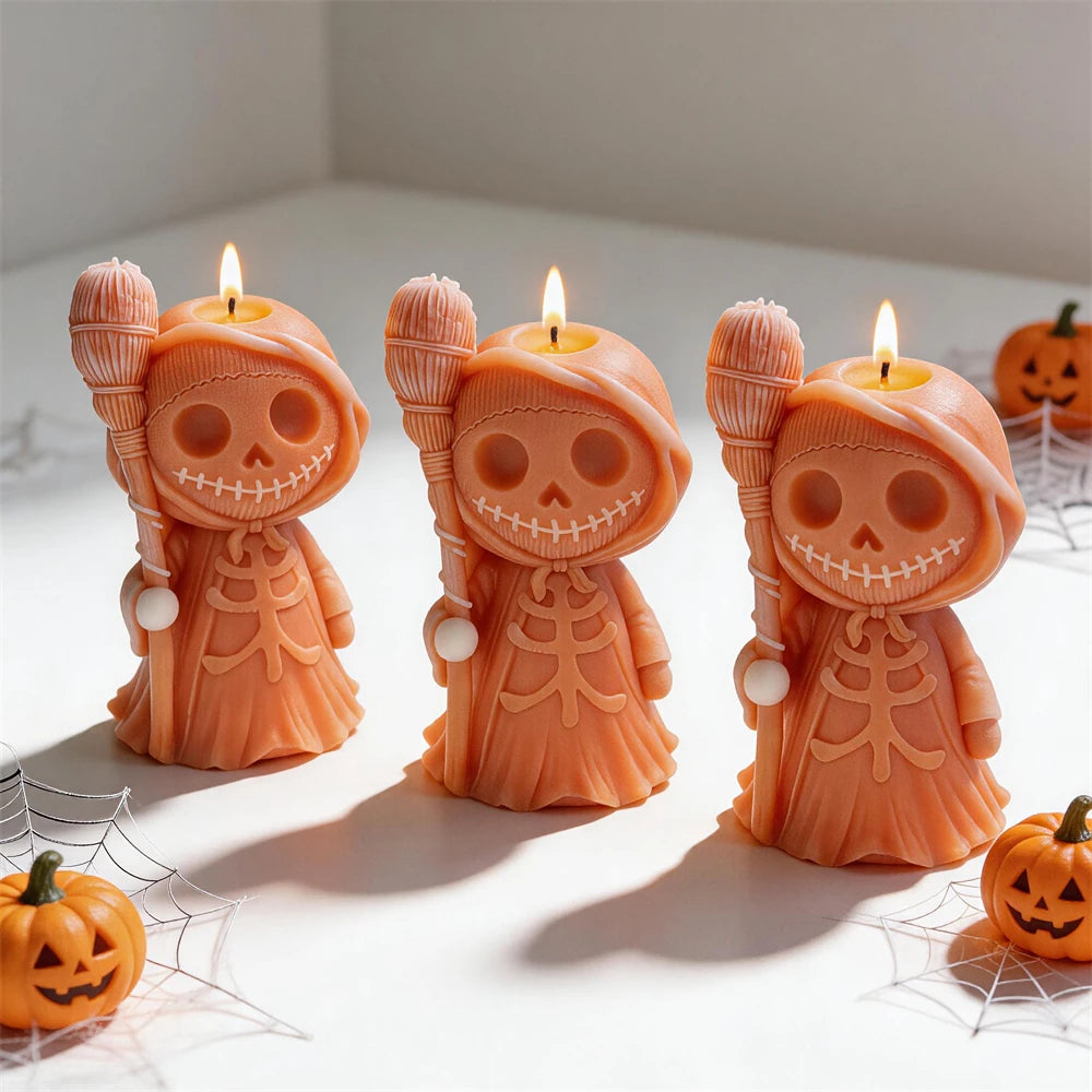 Three orange skeleton candle figures with grinning skulls