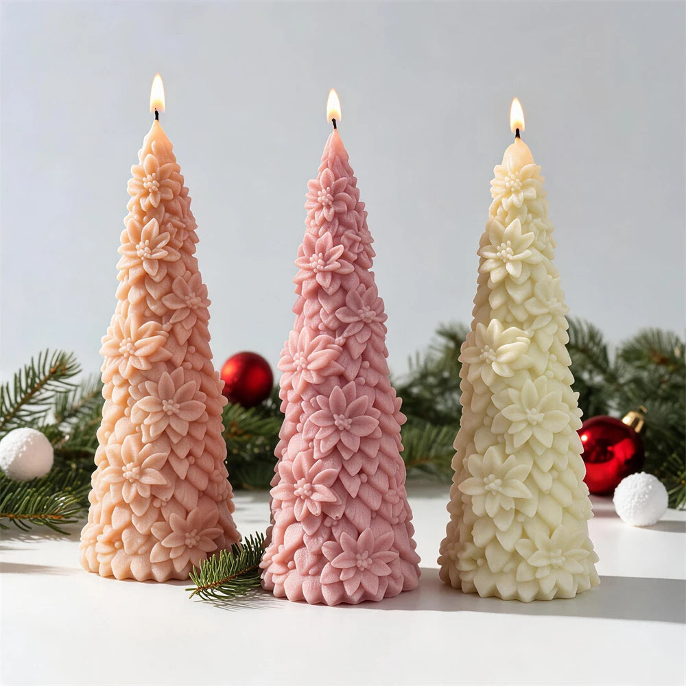 Flower-covered Christmas tree candles beside festive greenery