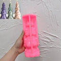 Pink silicone ribbon-banded tree mold beside finished examples