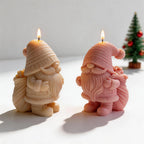Two gnome candles showing beards, mittens and gift sacks
