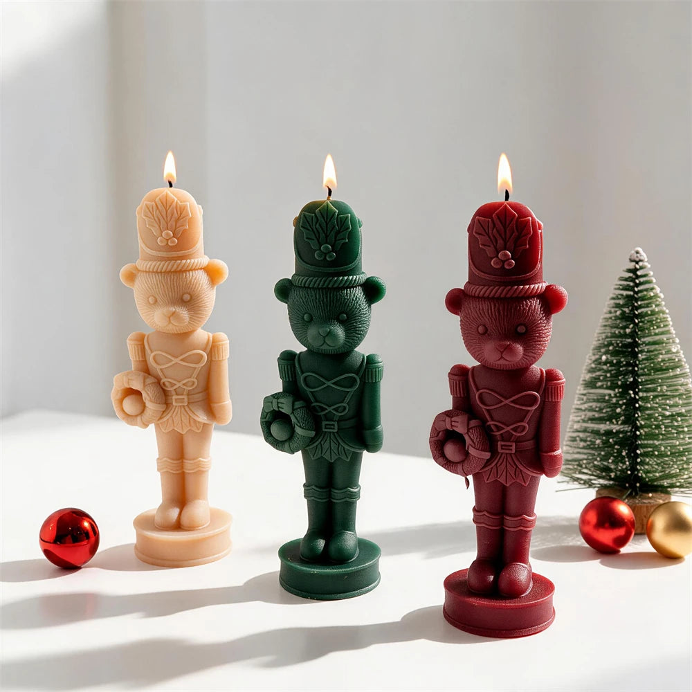 Bear nutcracker candle castings in festive colors viewed at an angle