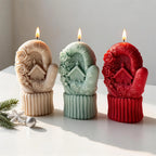 Beige, green and red Christmas cottage mitten candles arranged together