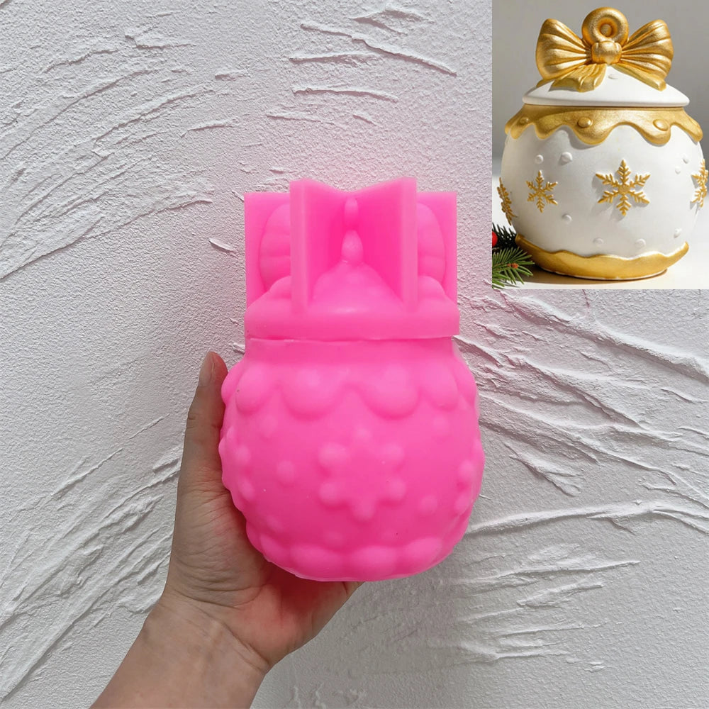 Pink silicone mold for snowflake-bow ornament with gold design inset
