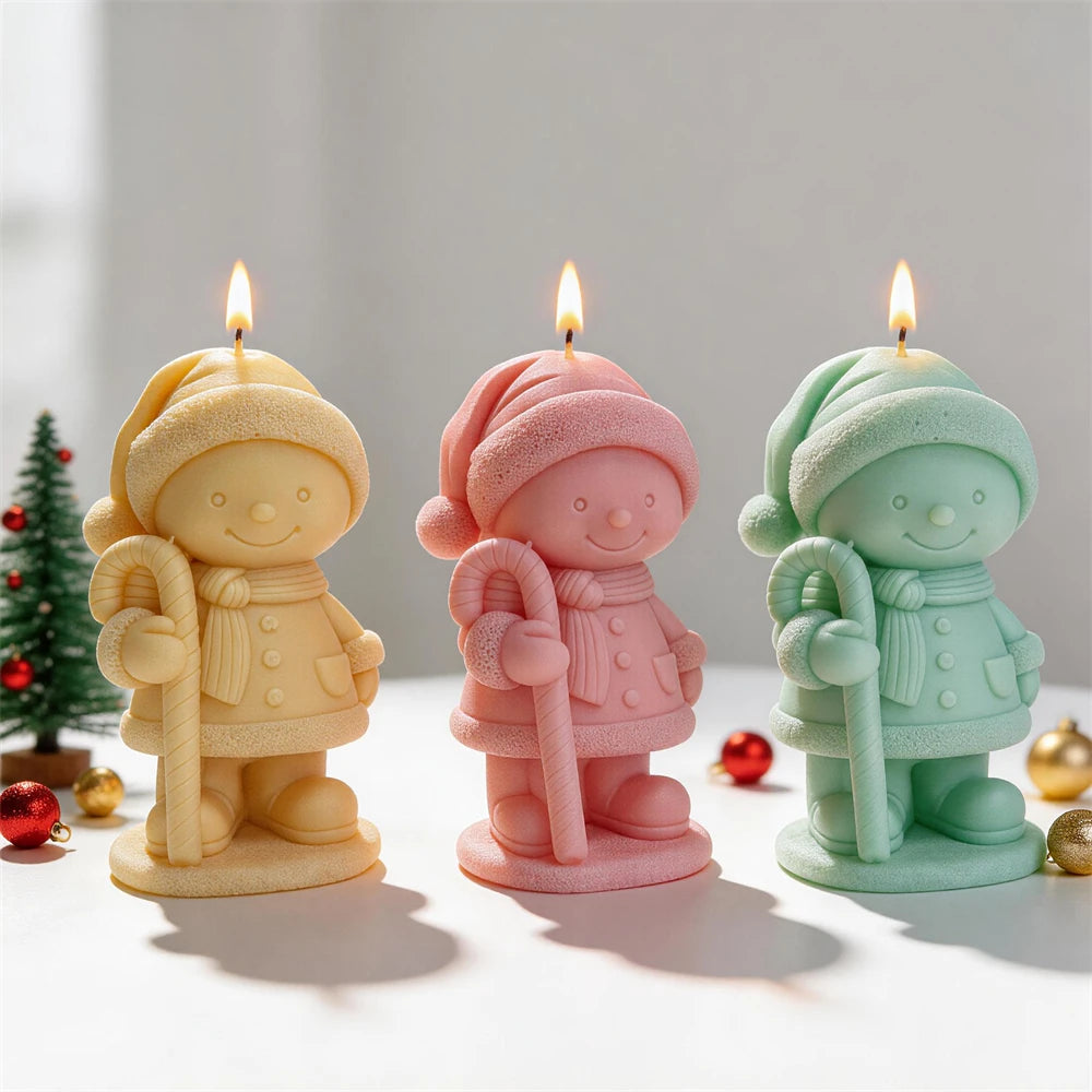Yellow pink and green winter figure candles holding candy canes