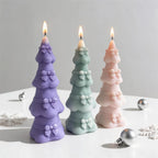 Three bow-decorated tree castings in purple green and peach
