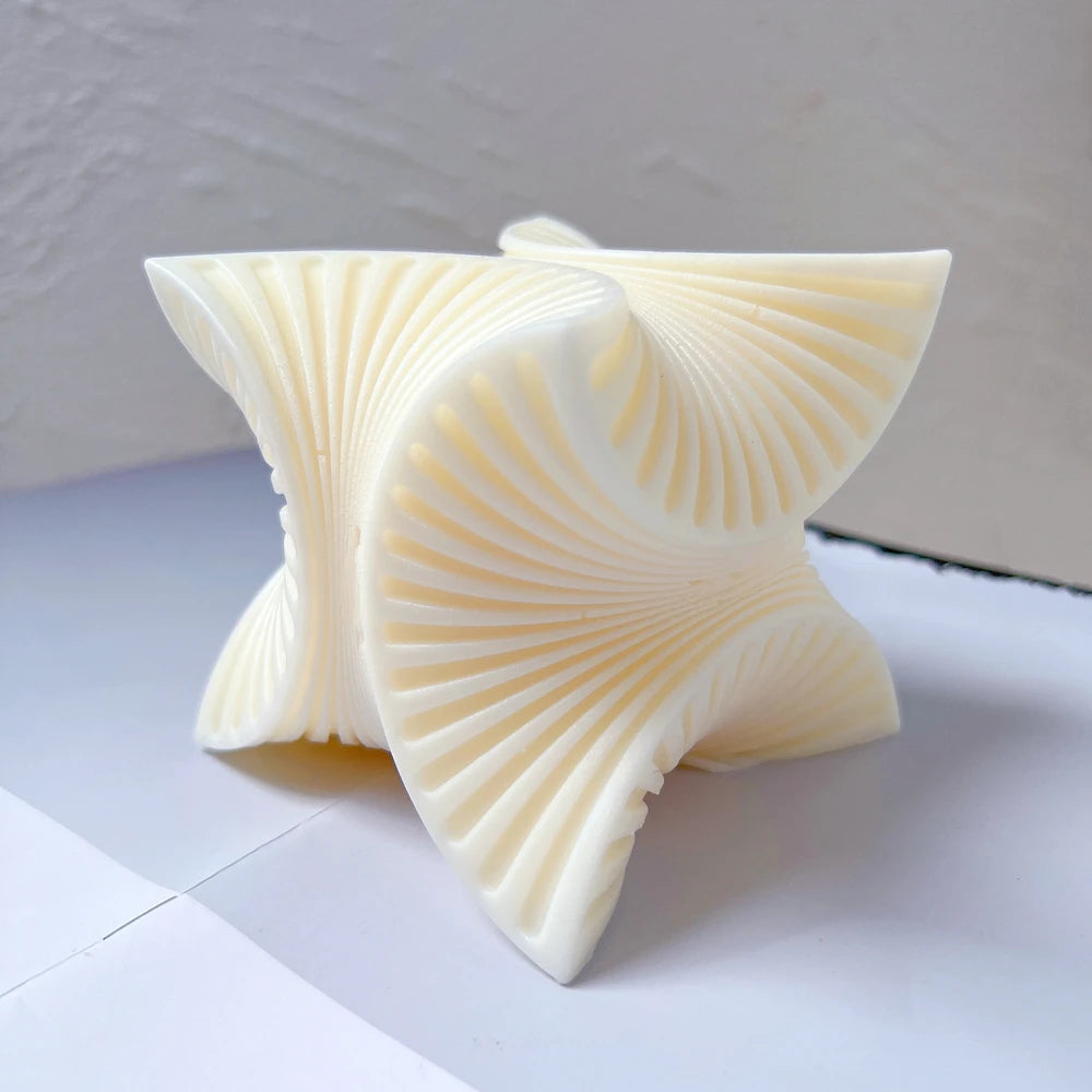 Sculptural swirl casting with four curved ribbed fan faces