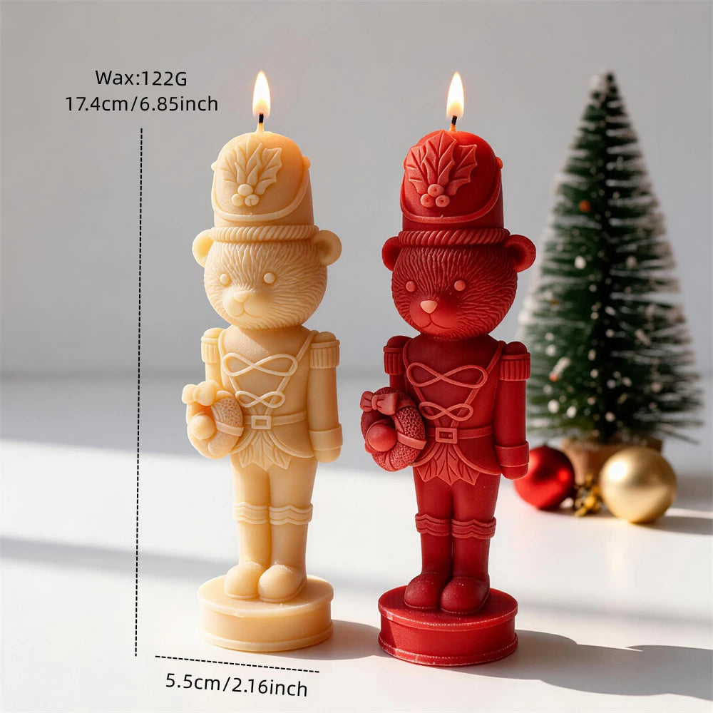 Bear nutcracker candles in cream and red beside a small Christmas tree