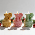 Yellow pink and green gingerbread figures seated on cupcake bases