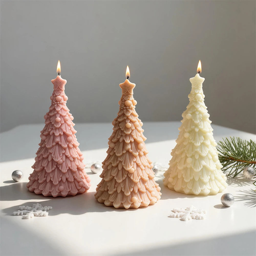 Three star-topped Christmas tree candles with layered branch detail
