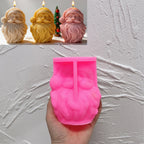 Pink silicone Santa face mold held beneath finished examples