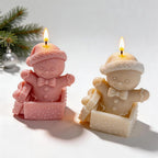 Two gingerbread figures in gift boxes with sculpted present details