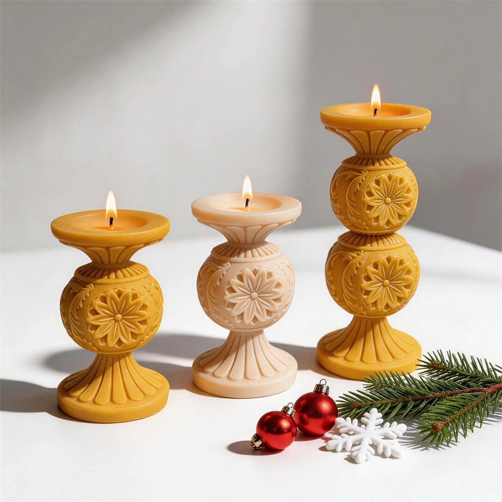 Gold and cream single-globe snowflake pedestal candles beside the taller double-globe version