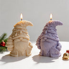 Two Christmas gnome candles showing layered hats and long beards