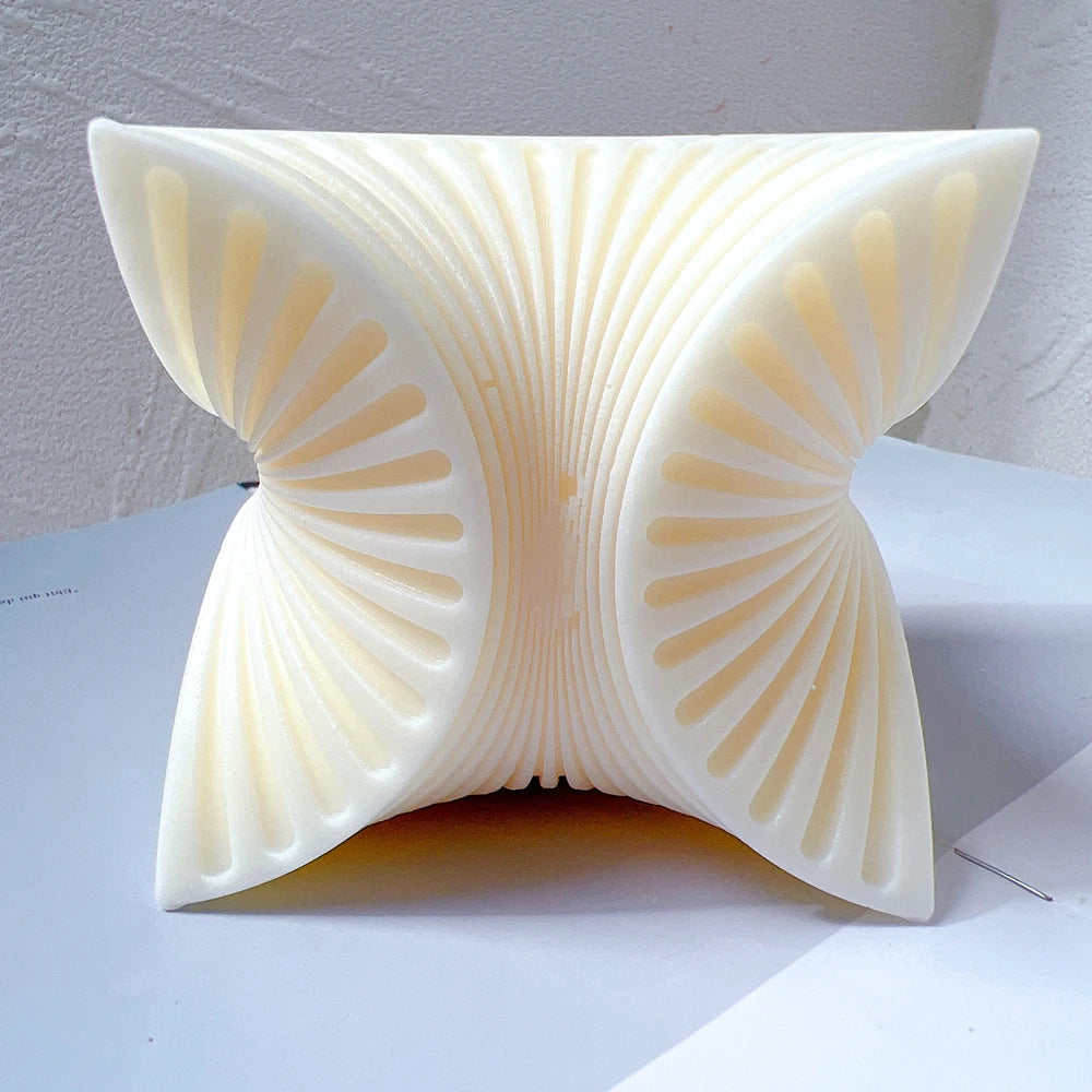Front view of four curved fan forms meeting at the center