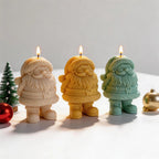 Three Santa candles with textured hat trim and small boots