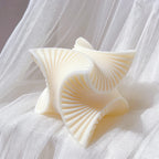 Ivory four-fan sculpture resting on fabric