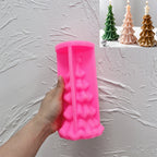 Pink scalloped Christmas tree silicone mold held in one hand