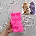 Pink silicone Christmas bear mold held beneath finished examples