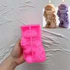 Pink silicone Christmas bear mold held beneath finished examples