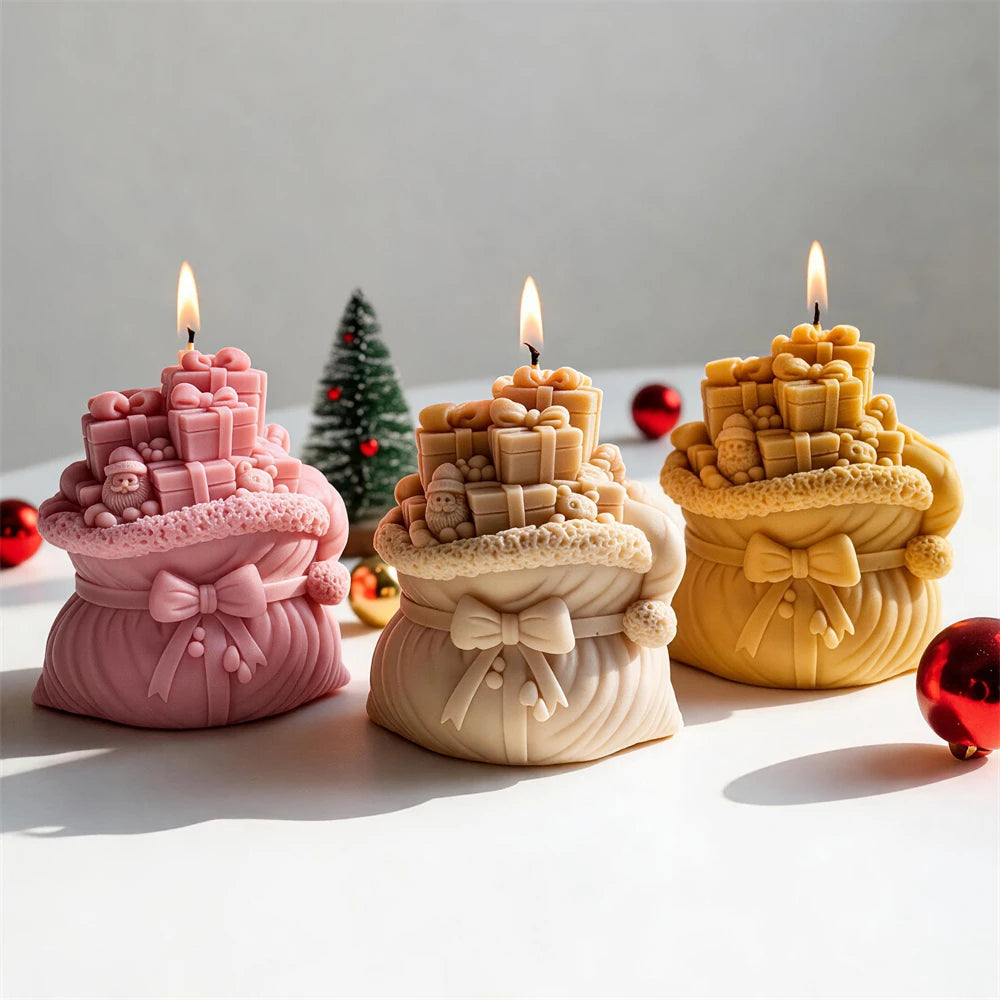 Pink cream and gold Christmas gift-sack candles arranged together