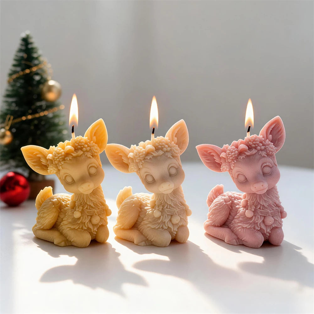 Cream pink and yellow sitting reindeer candles with large ears and floral headbands