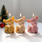 Cream pink and yellow sitting reindeer candles with large ears and floral headbands