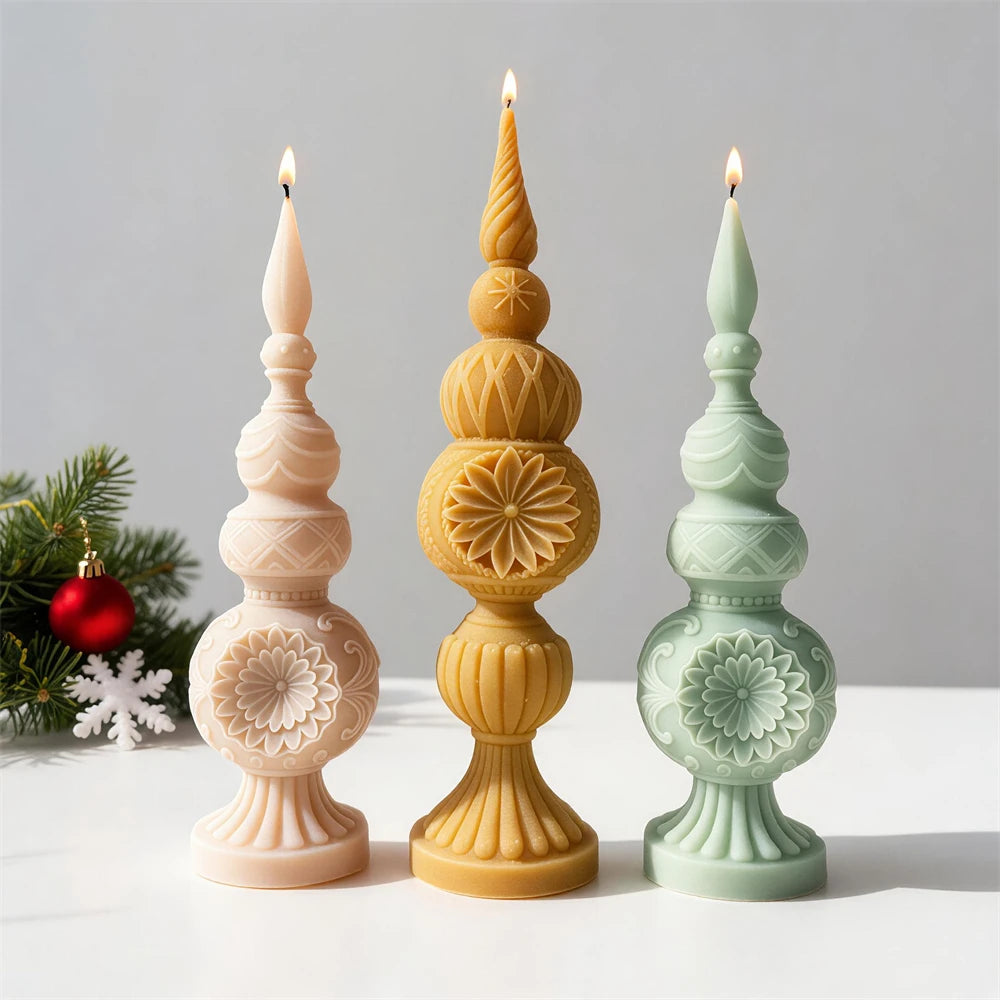 Three finial candles showing floral relief and textured sections