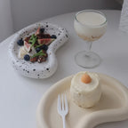 Kidney-shaped tray casting staged with food and a stemmed glass