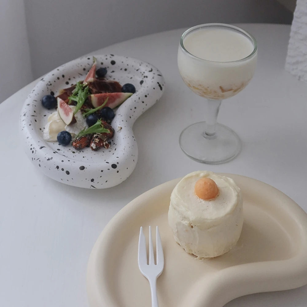 Kidney-shaped tray casting staged with food and a stemmed glass